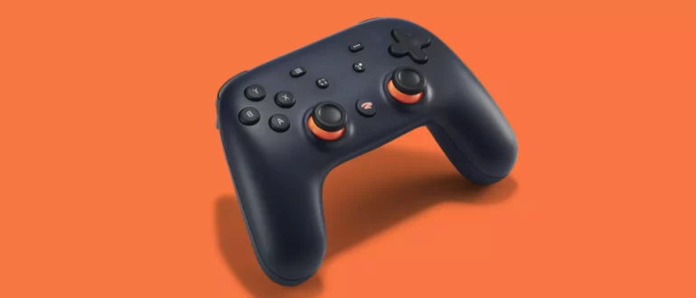Un controler de joc video Google Stadia pe un fundal portocaliu.