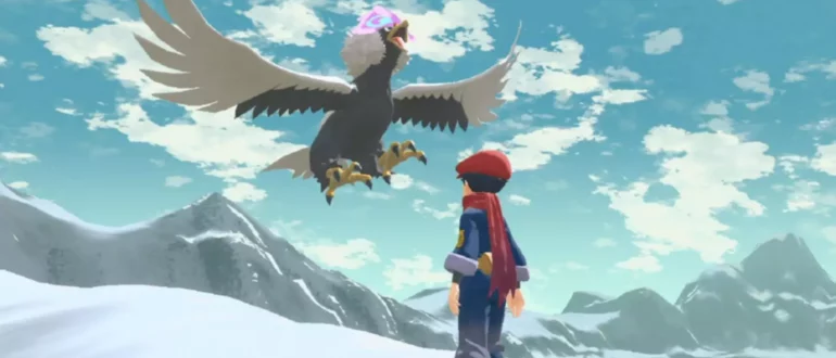 Skærmbillede af Pokemon Legends Arceus med en figur, der ser på flyvende Pokemon på et sneklædt bjerg